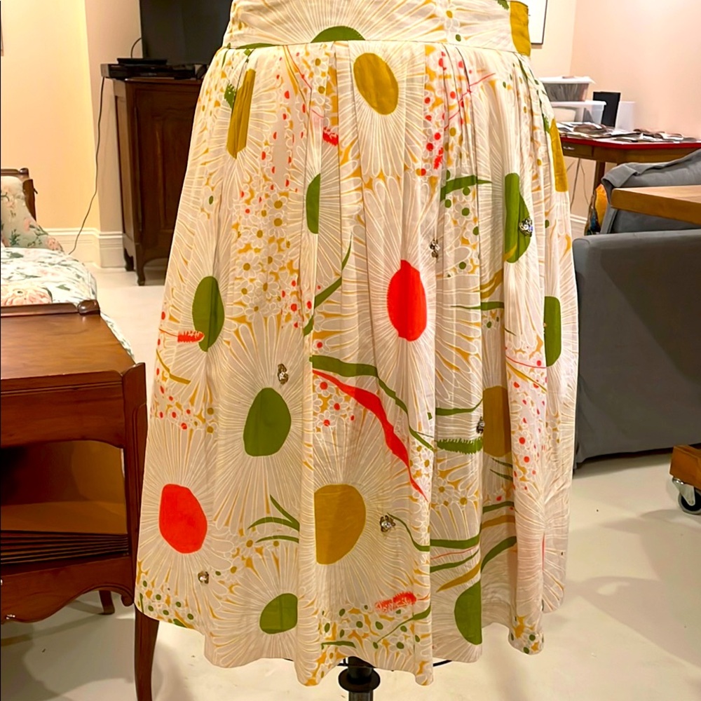 Pleated lined brightly colored cotton skirt with sparkly embellishments.